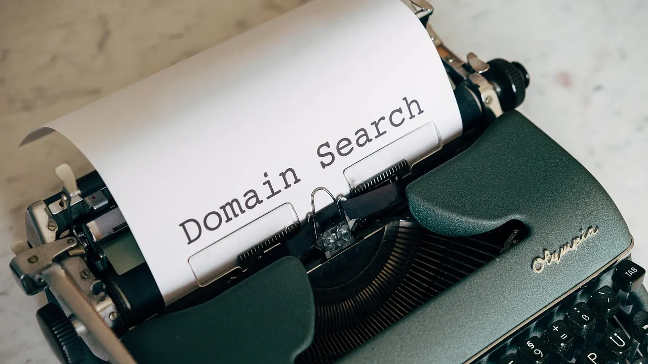 A laptop showing a .com vs .com.au domain name search for a new business website